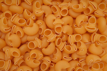 Raw pasta close-up, bright golden hue.