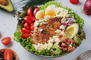A bowl with cobb salad, traditional American dish	