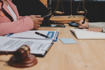 Consultation and conference of professional businesswoman and Male lawyers working and discussion having at law firm in office. Concepts of law, Judge gavel with scales of justice
