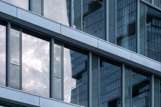 Glass and metal structure detail of contemporary architecture with clean linear design and reflections ideal for modern business visual themes.