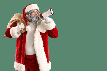 Santa Claus with bag full of gifts and megaphone on green background
