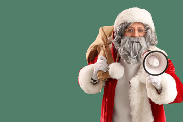 Santa Claus with bag full of gifts and megaphone on green background