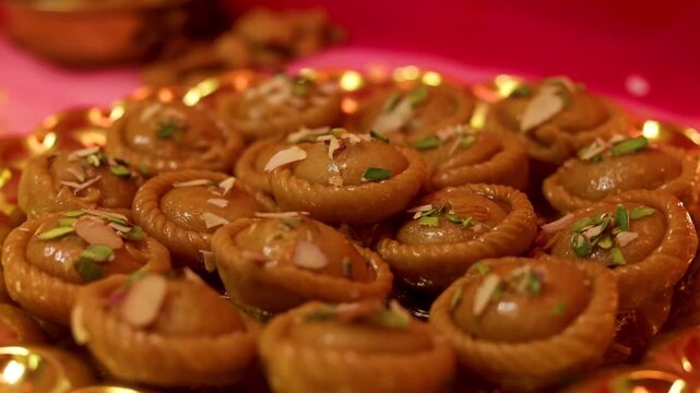 Chandrakala beautifully decorated in a golden plate with festive celebration background