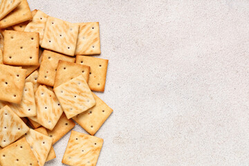 Heap of tasty crackers on beige grunge background, closeup