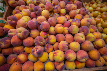 A stack of peaches is summer piled high in color and scent