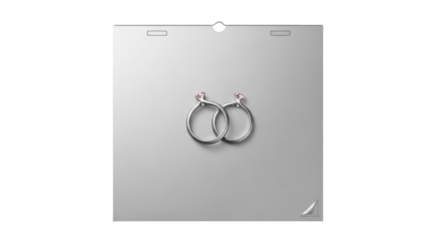 Isolated entwined wedding rings with pink gemstones are displayed on neutral surface.