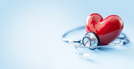 Stethoscope and red heart background with copy space