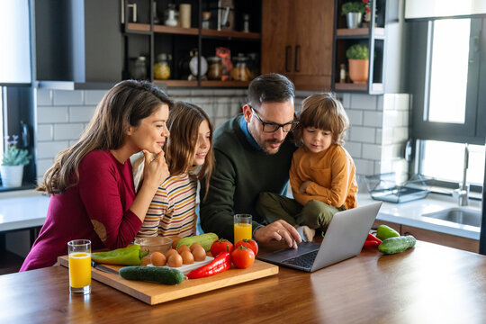 A happy family is cooking together in a bright kitchen, showing joy, teamwork, and love at home
