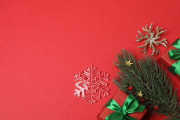Festive scene with wrapped gifts, candies and decorations, sometimes on a bright red background,...