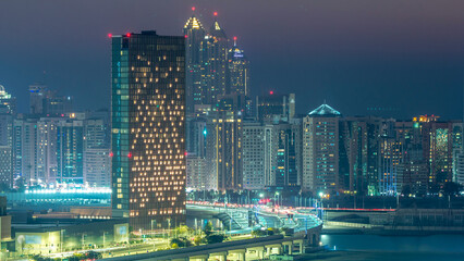 Obraz premium Buildings on Al Reem island in Abu Dhabi day to night timelapse from above.