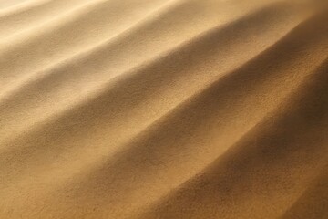 Close-up of golden sand dunes with smooth ridges&mdash;capturing natural symmetry, depth, and desert beauty.