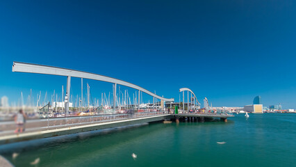 Rambla de Mar wooden walkway timelapse over Port Vell in the city of Barcelona at day in Catalonia, Spain.