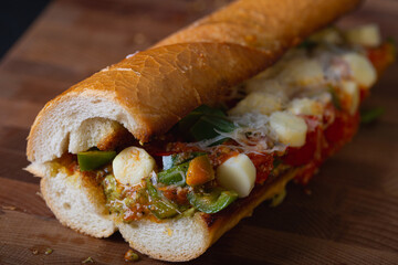 Sandwich with baked tomatoes, bell peppers and cheese