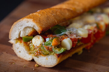Sandwich with baked tomatoes, bell peppers and cheese