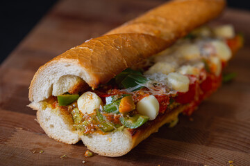 Sandwich with baked tomatoes, bell peppers and cheese