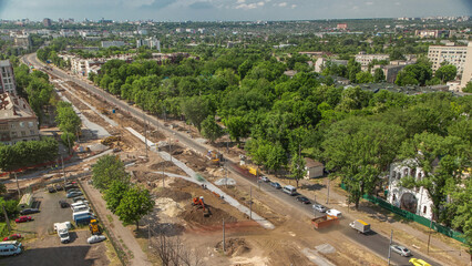 Big road construction site. Industrial truck loader excavator moving earth and loading into a dumper truck timelapse