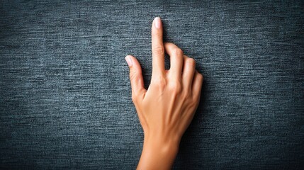 Hand pointing on textured fabric background