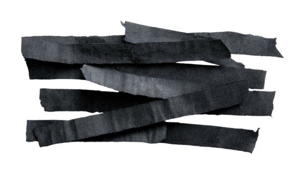 Monochrome shot of torn, textured, dark-gray strips haphazardly arranged against black