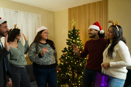 Friends leaving and saying goodbye at the end of the christmas celebration