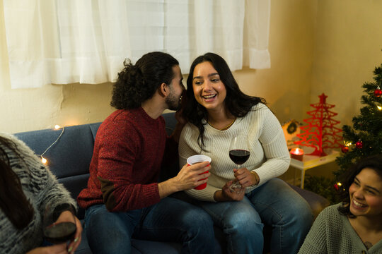 Friends whispering and laughing at christmas reunion party - Powered by Adobe