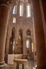 View of the altar in the Alcobaca Monastery with rounded arches and natural light in a heritage and religious setting
