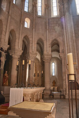View of the altar in the Alcobaca Monastery with rounded arches and natural light in a heritage and religious setting