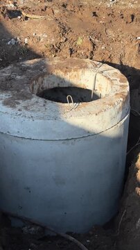Installation of new septic tank made of precast concrete rings. Sewage system on the site. Vertical