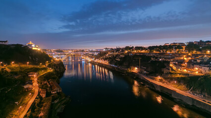 Fototapeta premium Day to night view of the historic city of Porto, Portugal timelapse with the Dom Luiz bridge