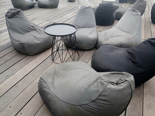 Sacco chairs or beanbags made of thick fabric are used as outdoor furniture. A comfortable...
