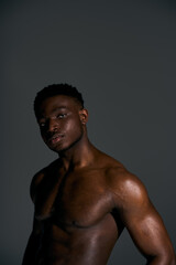 Fototapeta premium Muscular African American man posing confidently in a studio setting