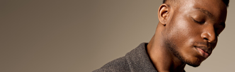 Obraz premium Stylish African American man showcases autumn fashion in a studio setting