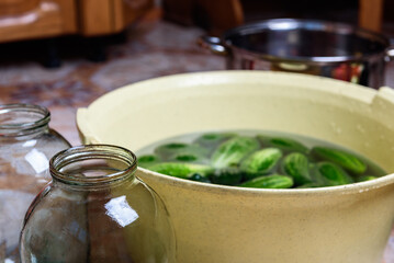 Preservation of season vegetables. Washing cucumbers before the preparation of canned food, the cooking process.