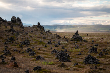 Ancient Stone Formations Dotting a Vast, Arid Landscape Under a Cloudy Sky