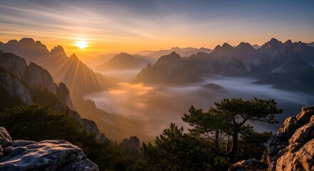 Beautiful mountain landscape at sunrise with misty fog in the valley and vibrant blue sky
