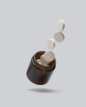 White round tablets fly out of an amber glass jar on a clean background, symbolizing health, medicine and pharmaceutical care.