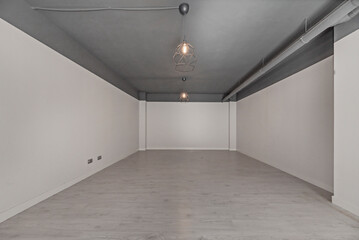 Residential basement with white-painted walls and neutral tile flooring, a blank space for custom design