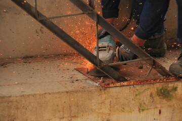construction worker climbing scaffolding inside building under construction