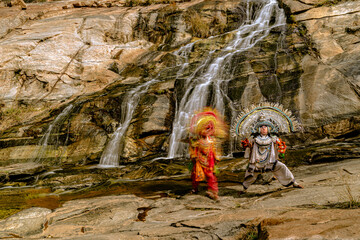 Traditional Folk Dancers Performing by a Waterfall in India