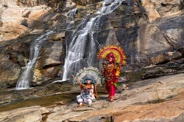 Traditional Folk Dancers Performing by a Waterfall in India
