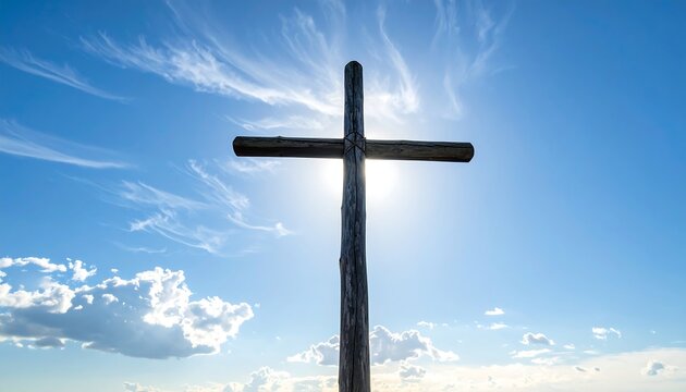 Wooden cross silhouette against a bright blue sky with clouds - Powered by Adobe