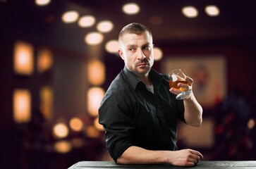 Handsome male barman with alcohol drink