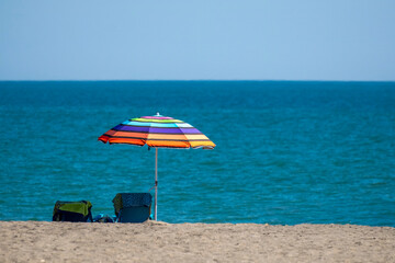 Colorful Umbrella and Chairs on Tropical Beach
