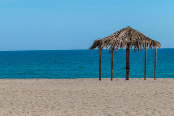 Wooden Gazebo with Palm Roof on Beach