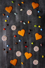 Various sweet food on black chalkboard background. Flat lay. Top view. Food concept.