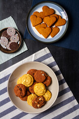 Bowl and plates with cookies on black chalkboard texture. Flat lay. Top view. Food concept. with...