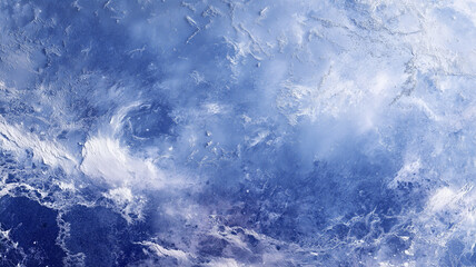 Abstract icy texture in shades of deep to light blue, with frosted patterns and crystalline formations. The surface appears cold and rugged, evoking frozen landscapes or winter skies from above