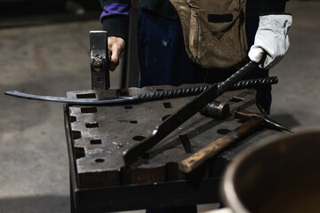 blacksmith working knife with iron hammer