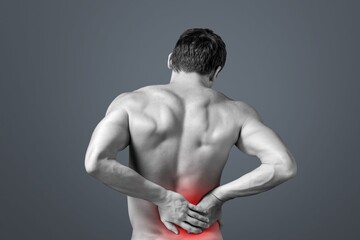 Young sporty man with pain in neck and back