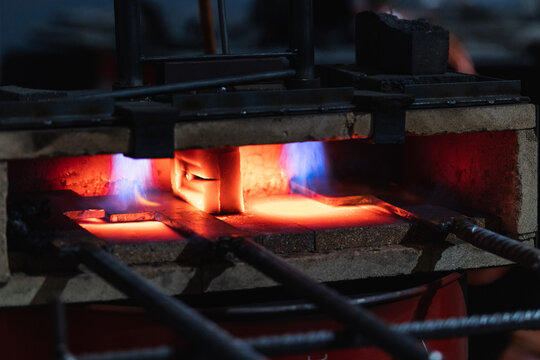 In front of a furnace, Steel burning process, forging the iron steel sword, Close up of burning wood fire in blacksmith furnace - Powered by Adobe
