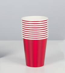Stacked red plastic glasses isolated nature background with clipping path